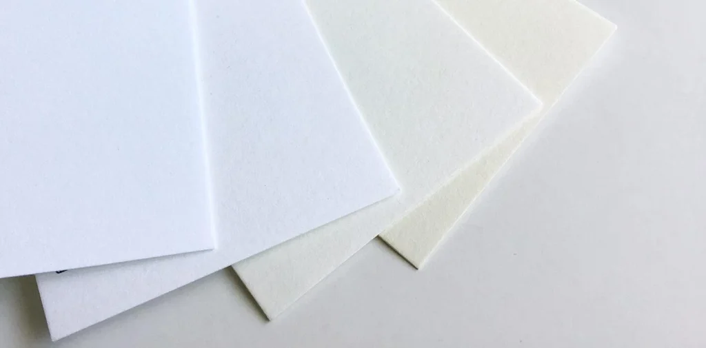 Stacked commercial paper material sheets with different surfaces